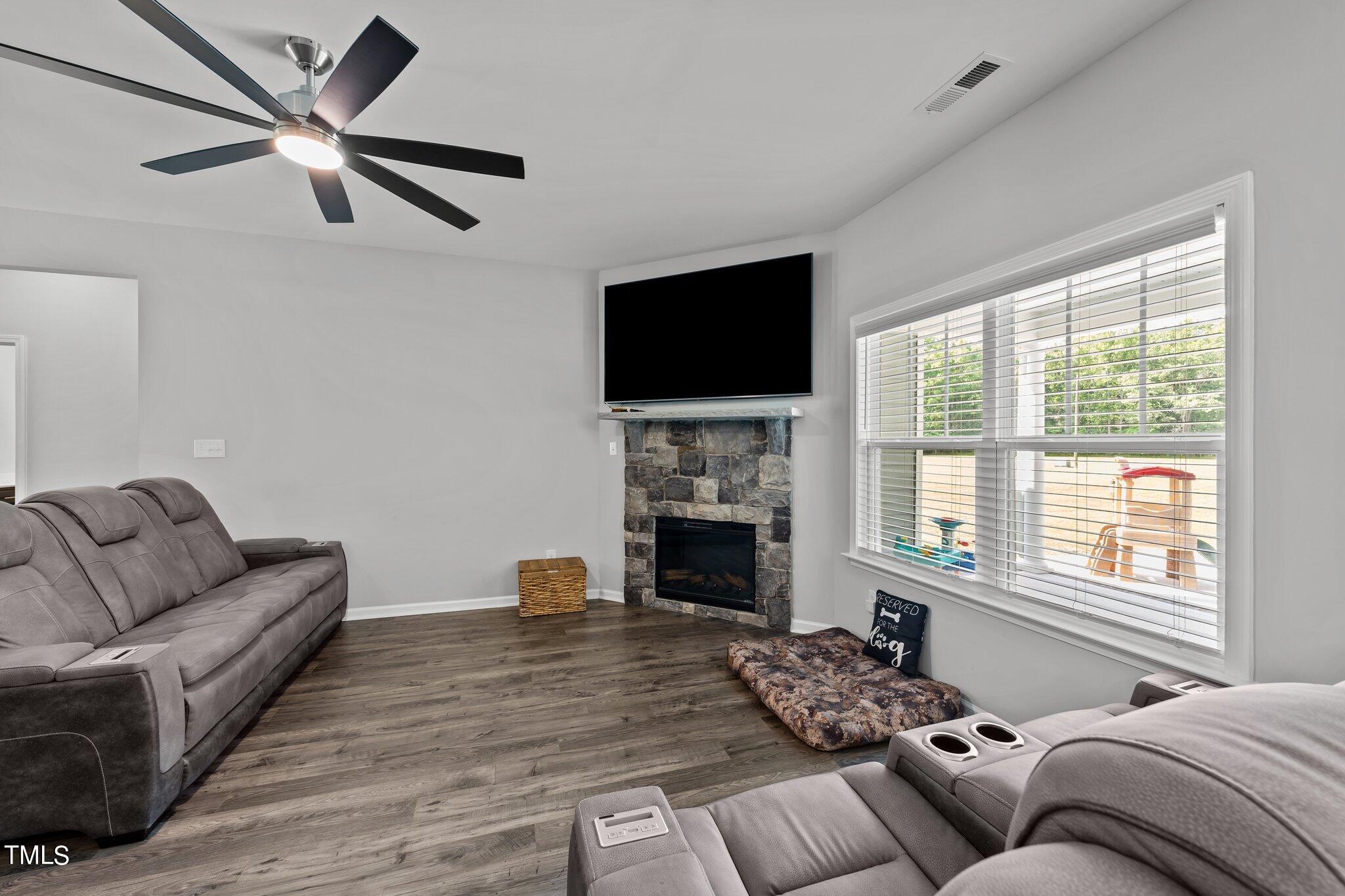 7588 Sadie Road Kenly, NC 27542 - Photo 23 of 58 a bedroom with furniture fireplace and window