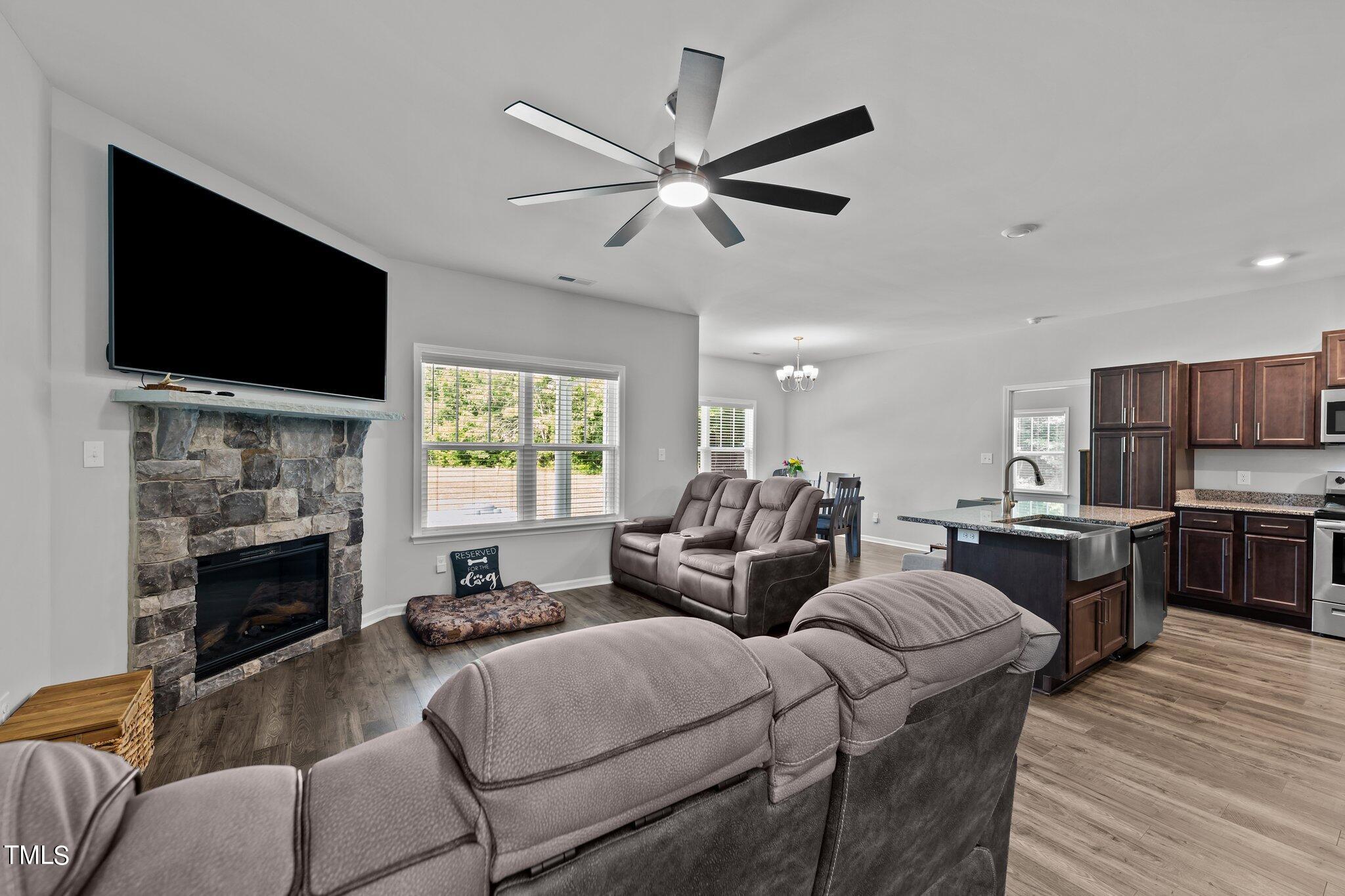 7588 Sadie Road Kenly, NC 27542 - Photo 24 of 58 a living room with furniture fireplace and flat screen tv