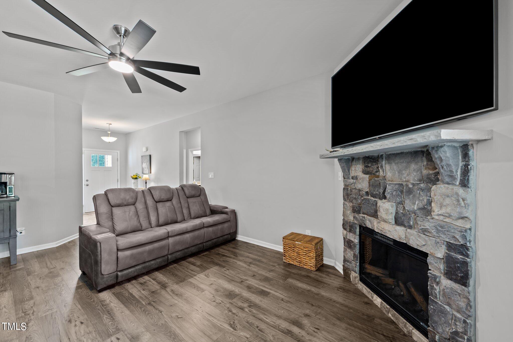 7588 Sadie Road Kenly, NC 27542 - Photo 25 of 58 a living room with furniture a flat screen tv and a fireplace