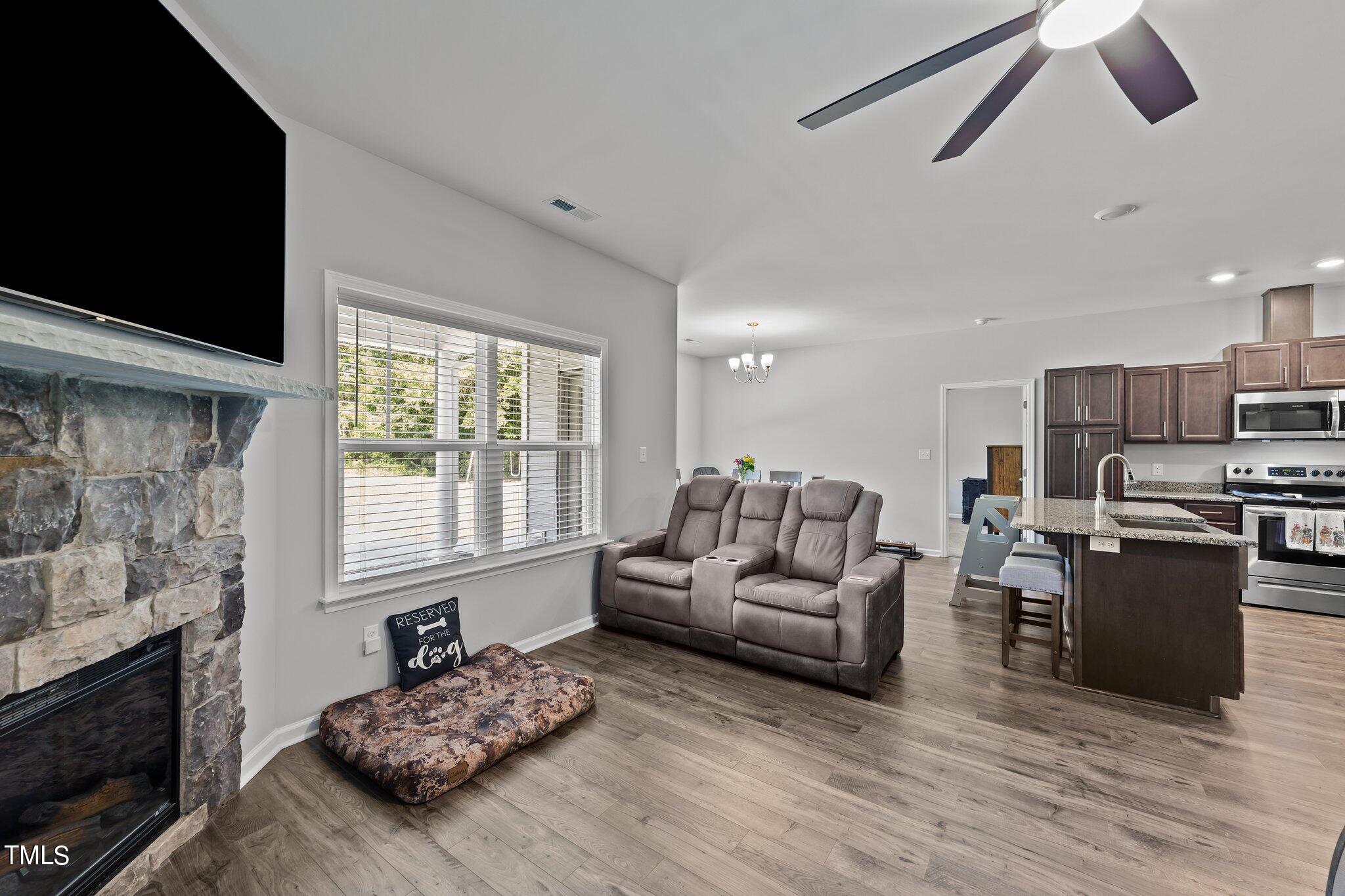 7588 Sadie Road Kenly, NC 27542 - Photo 26 of 58 a living room with furniture and a fireplace
