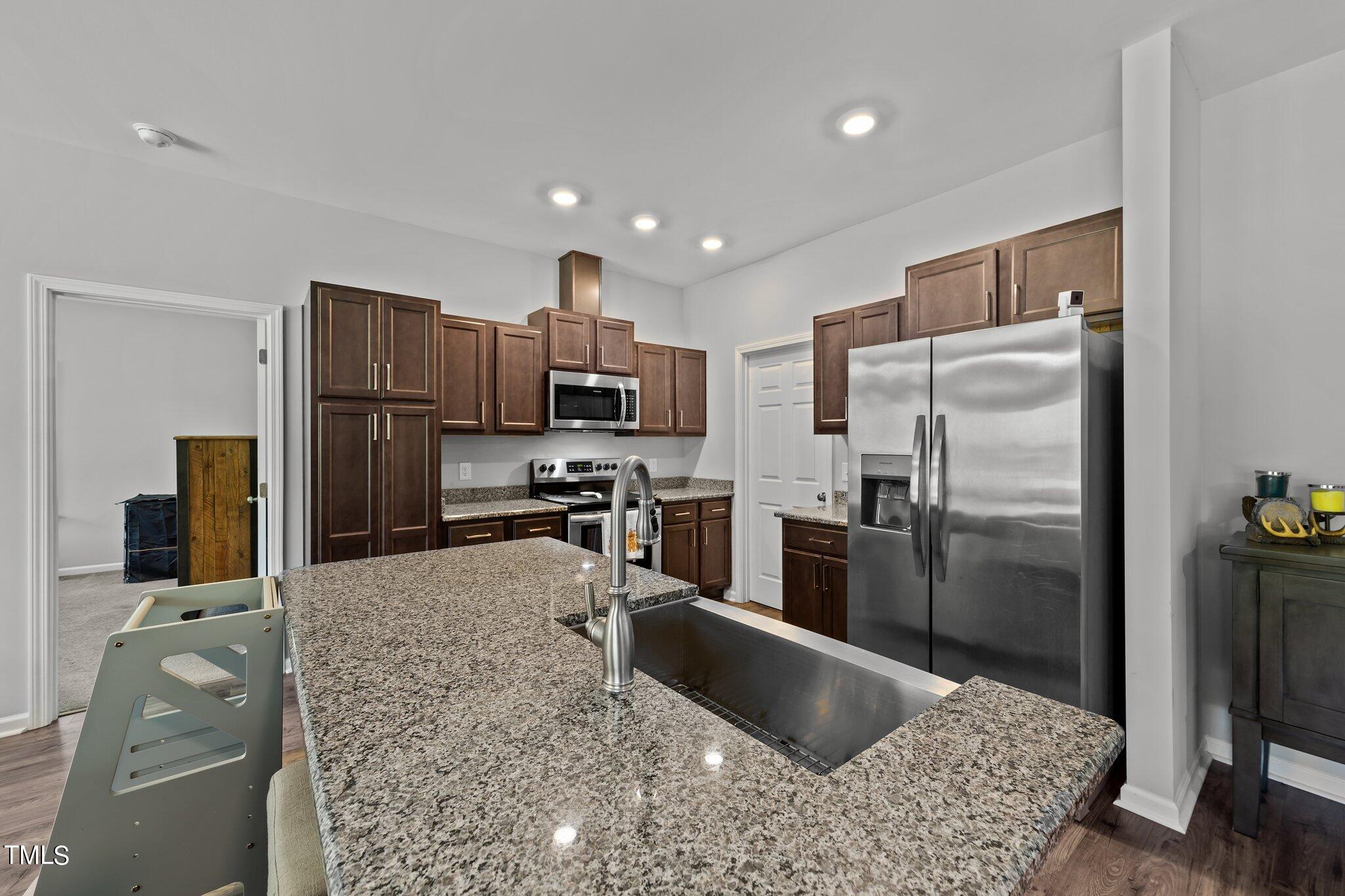 7588 Sadie Road Kenly, NC 27542 - Photo 28 of 58 a kitchen with a refrigerator sink and stainless steel appliances