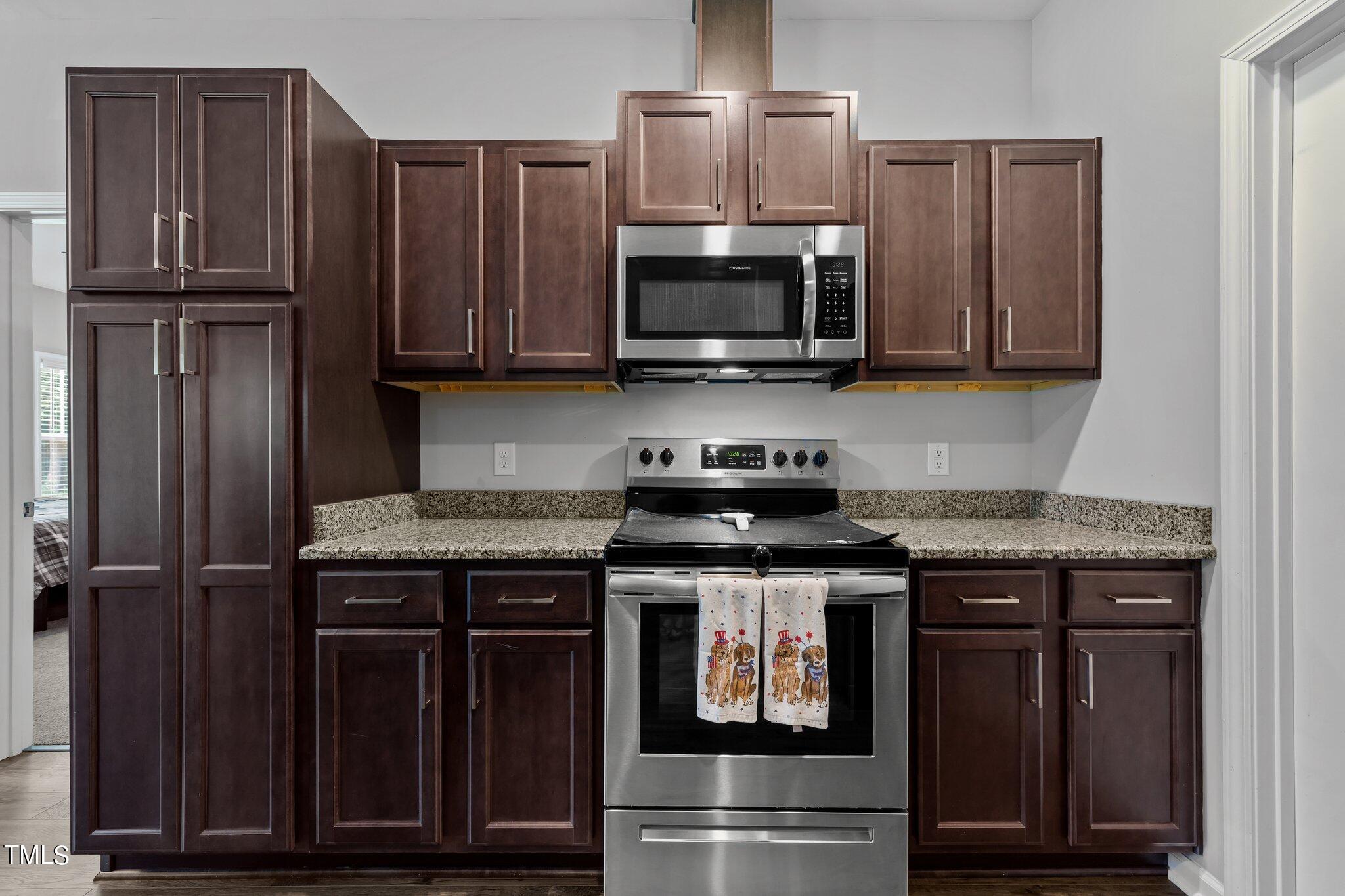 7588 Sadie Road Kenly, NC 27542 - Photo 36 of 58 a kitchen with granite countertop a stove and a microwave