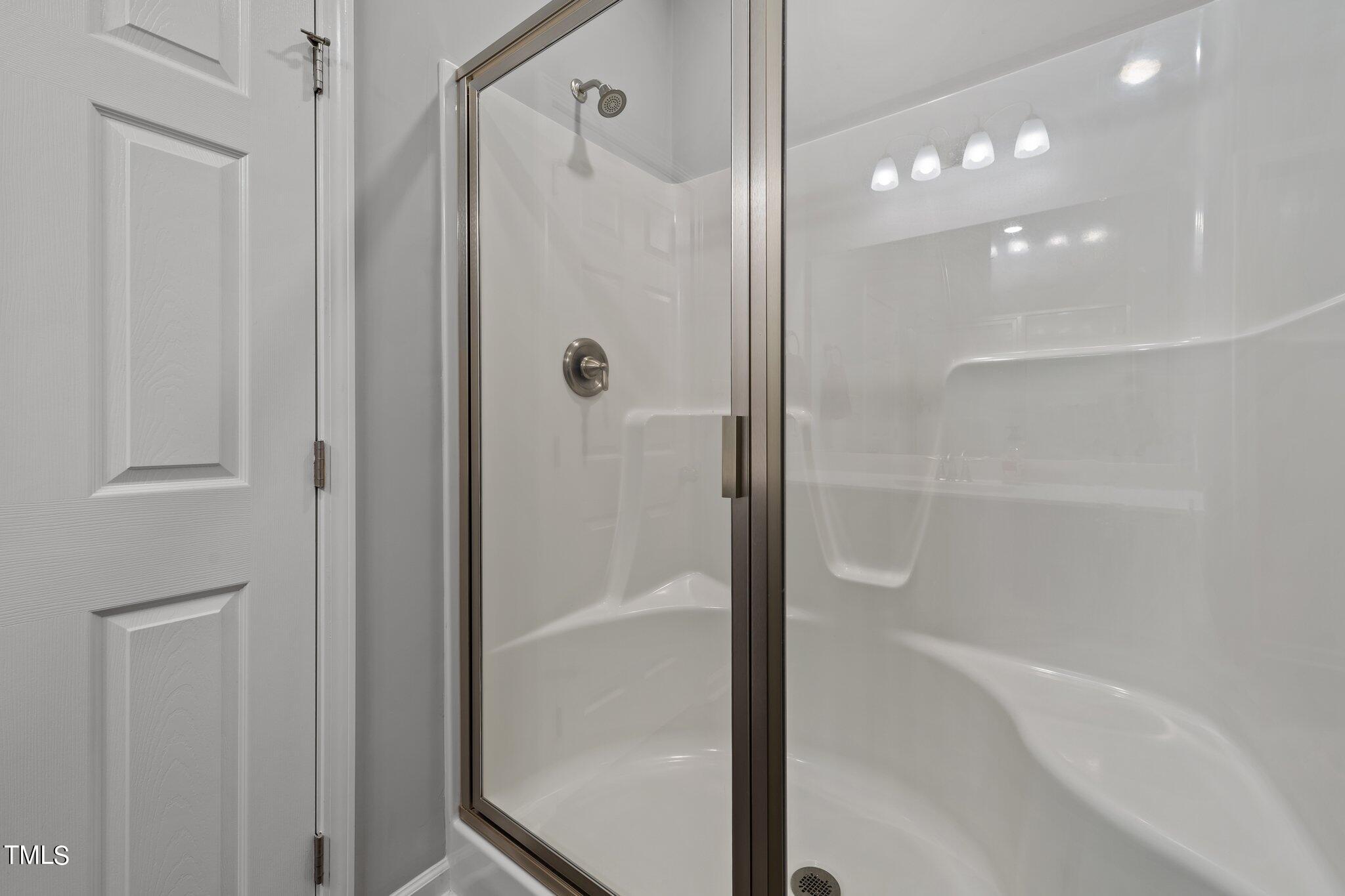 7588 Sadie Road Kenly, NC 27542 - Photo 43 of 58 a bathroom with a bathtub and a shower