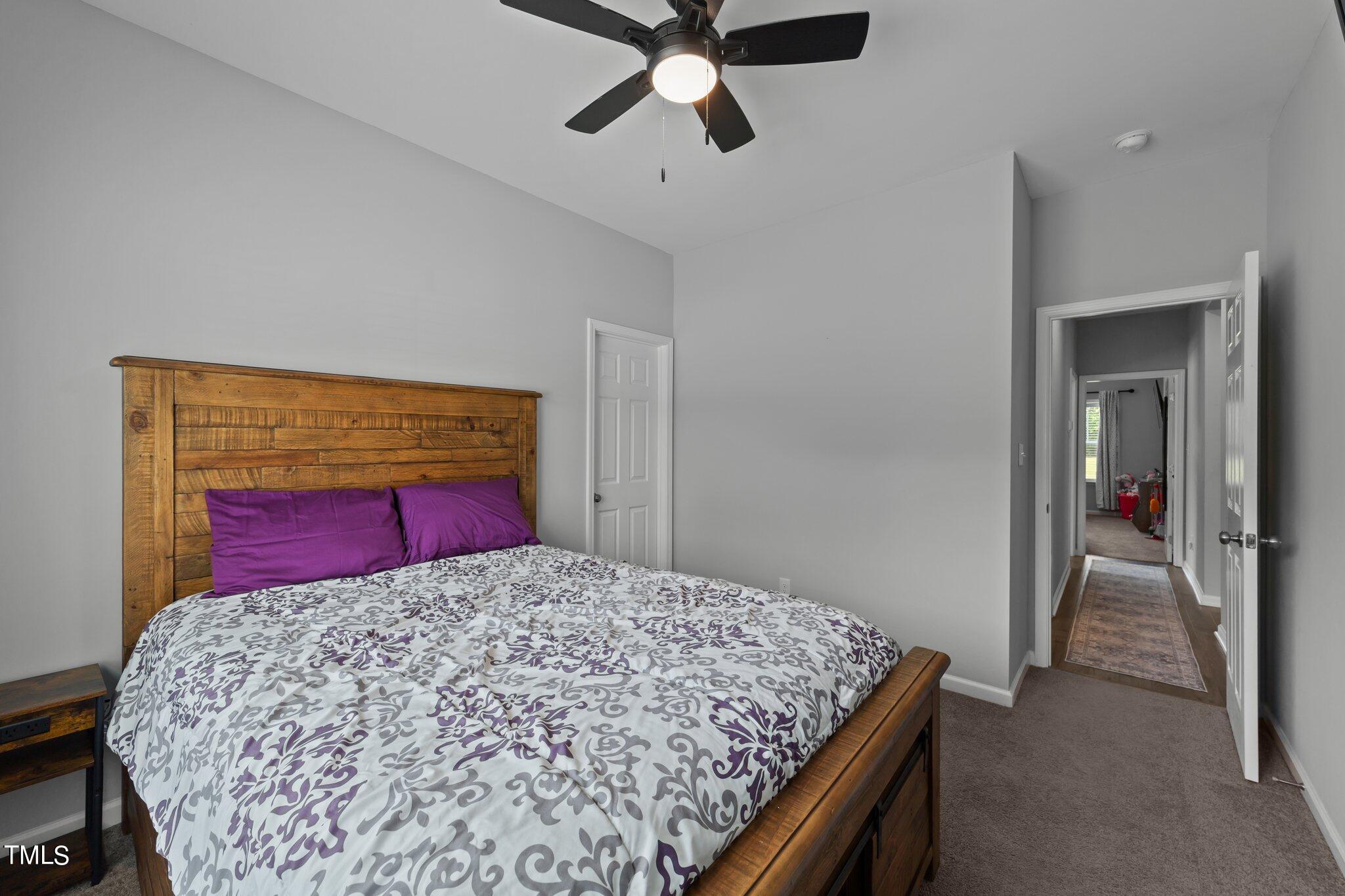 7588 Sadie Road Kenly, NC 27542 - Photo 50 of 58 a bedroom with a bed and a chandelier