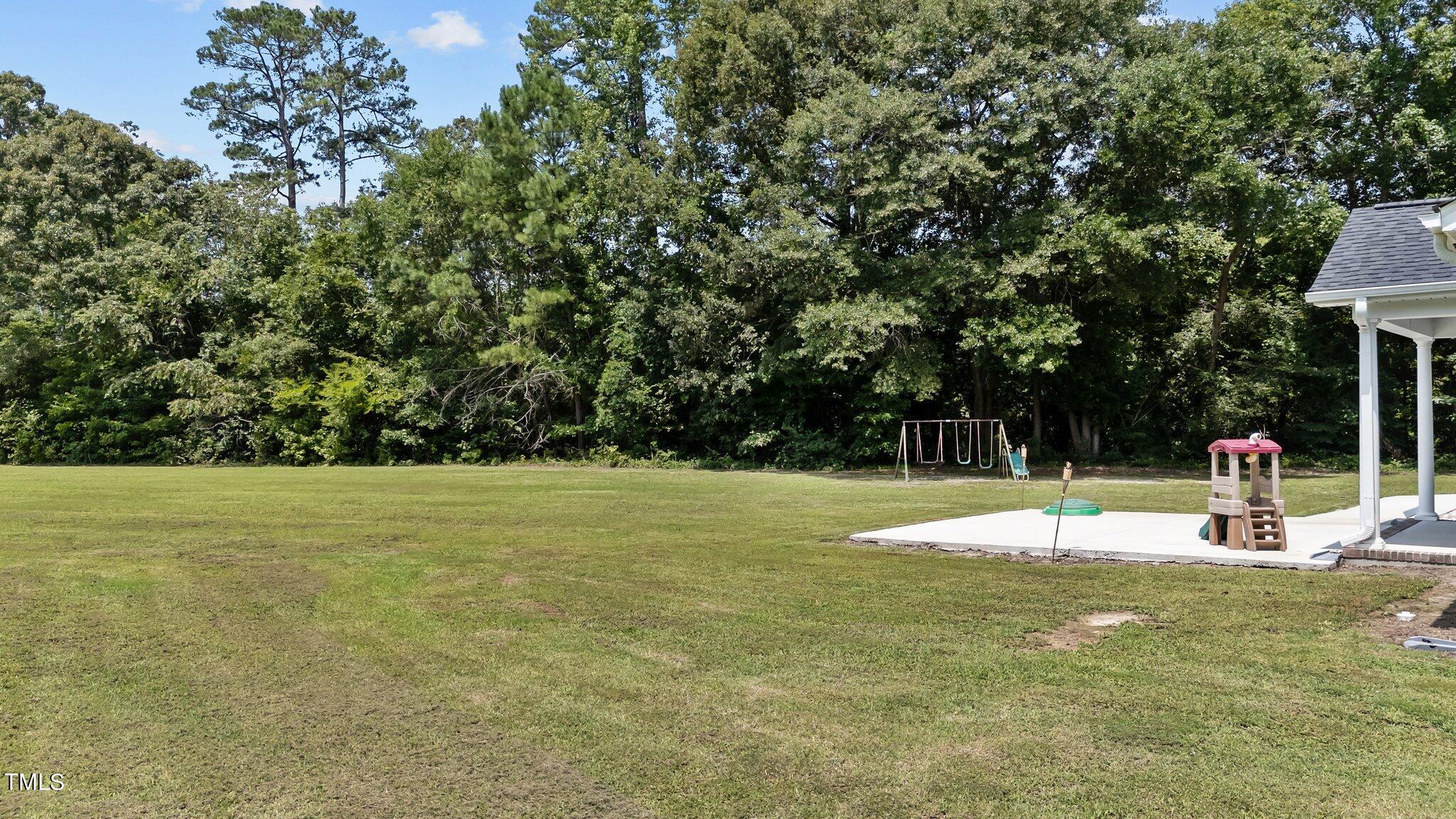7588 Sadie Road Kenly, NC 27542 - Photo 53 of 58 a view of a playground with basketball court