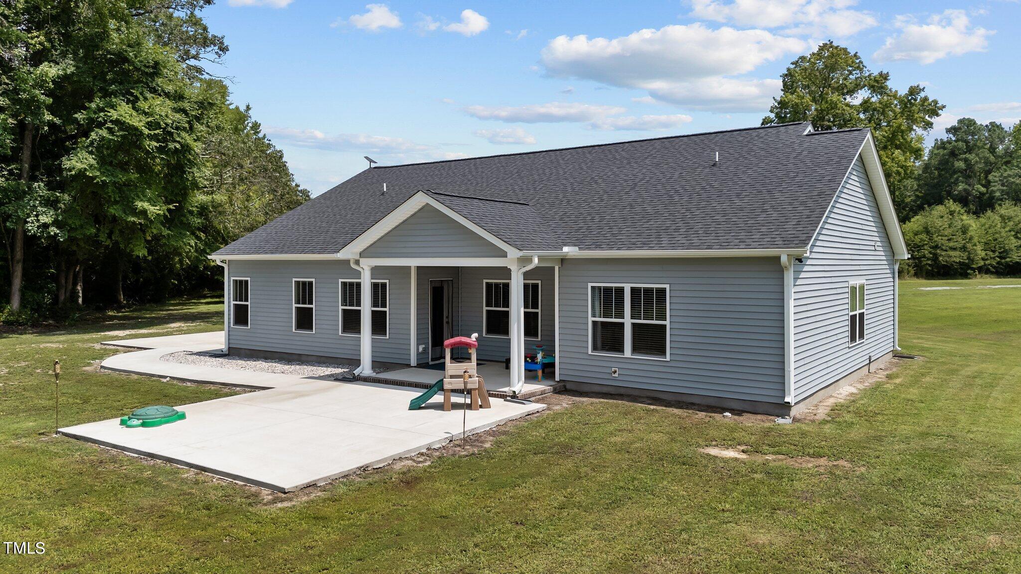 7588 Sadie Road Kenly, NC 27542 - Photo 54 of 58 a front view of a house with a yard