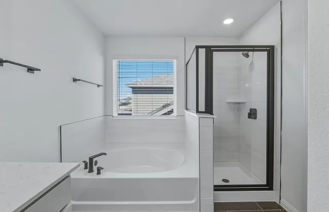 a bathroom with a bathtub and a shower