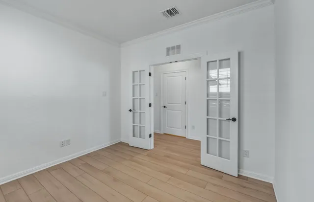 an empty room with wooden floor