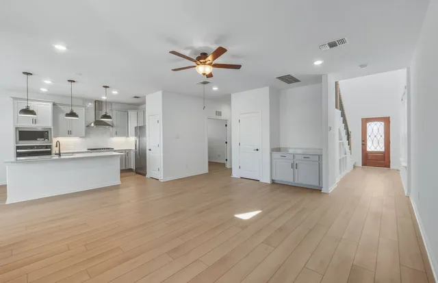 a view of a kitchen with wooden floor and a kitchen