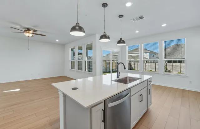 a view of a kitchen with wooden floor and a kitchen