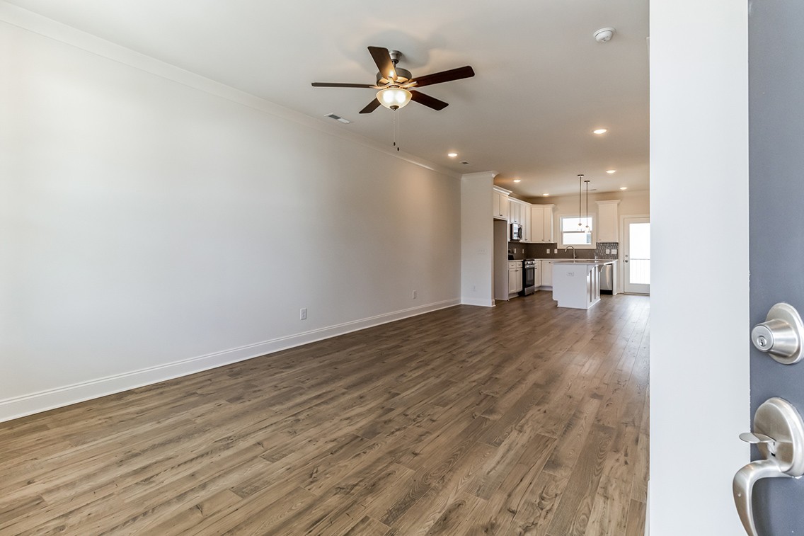 720 Fordham Drive Brentwood, TN 37027 - Photo 3 of 32 a view of an empty room and kitchen view with wooden floor