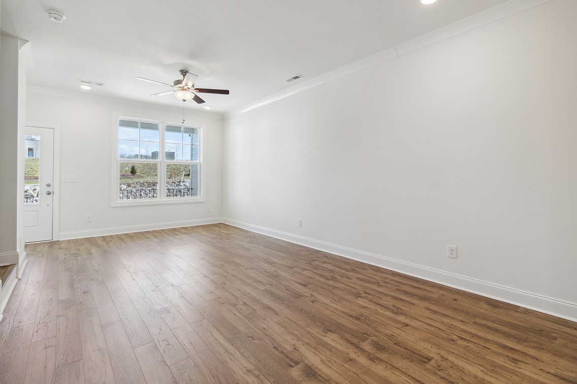 720 Fordham Drive Brentwood, TN 37027 - Photo 6 of 32 an empty room with wooden floor chandelier fan and windows