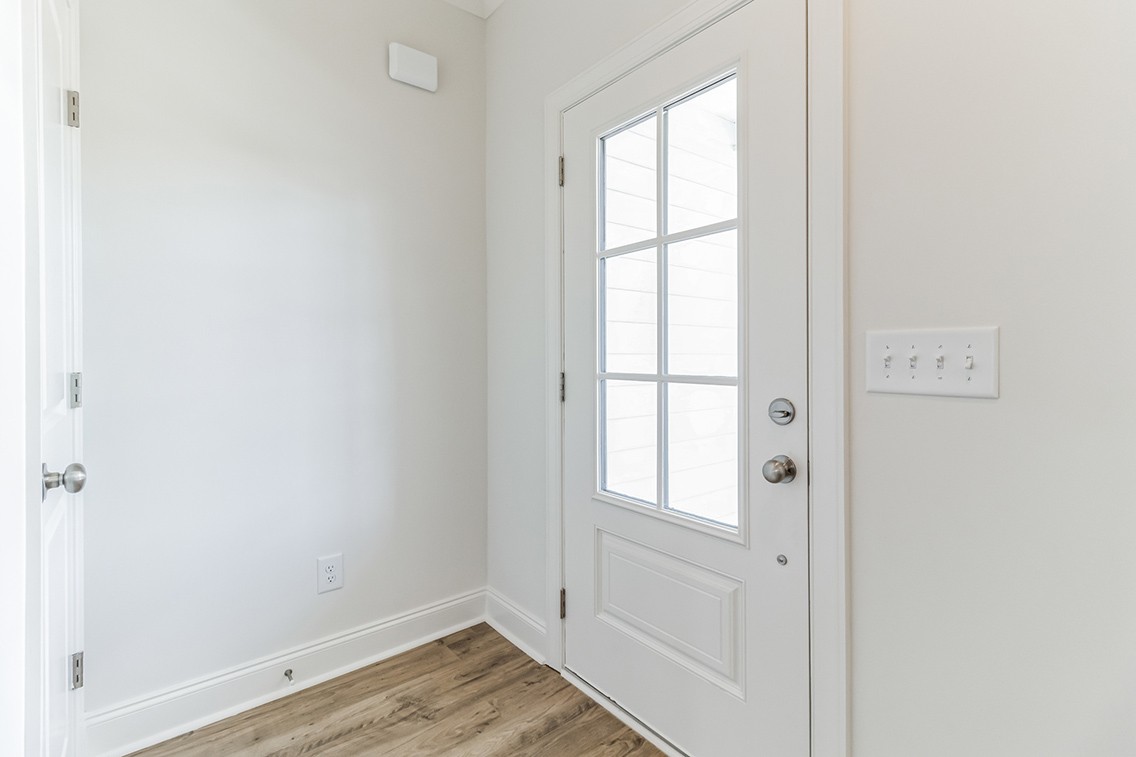 720 Fordham Drive Brentwood, TN 37027 - Photo 8 of 32 a view of an empty room with wooden floor and a window