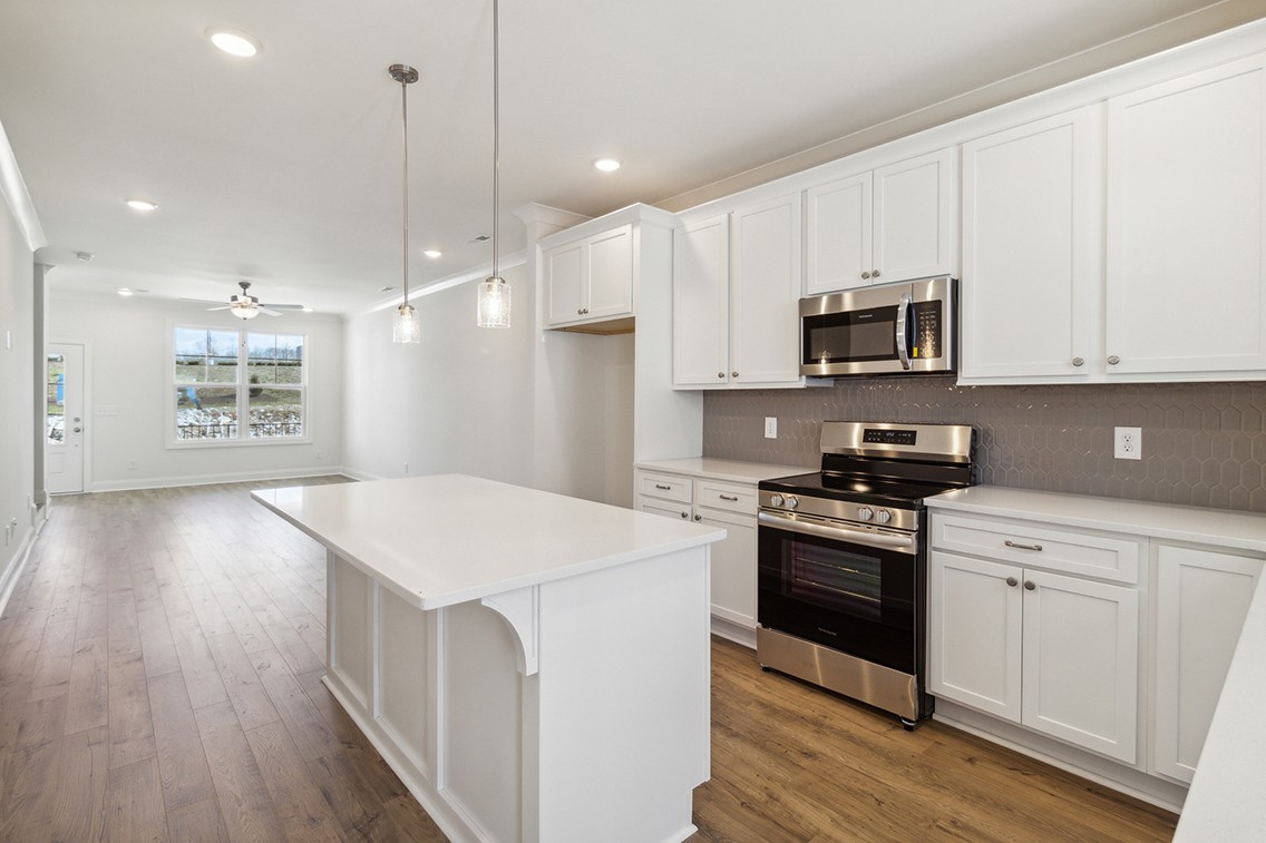 720 Fordham Drive Brentwood, TN 37027 - Photo 9 of 32 a kitchen with stainless steel appliances kitchen island granite countertop a stove a sink and a microwave
