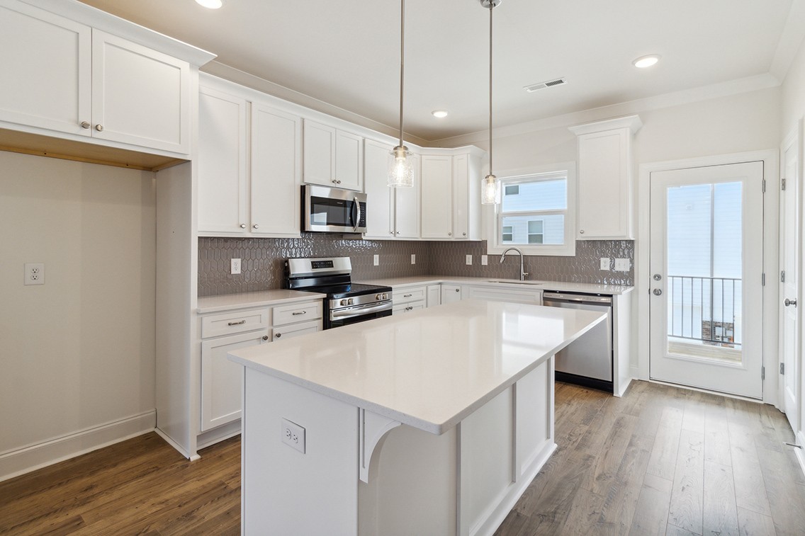 720 Fordham Drive Brentwood, TN 37027 - Photo 10 of 32 a kitchen with stainless steel appliances white cabinets a sink a stove a refrigerator and island with wooden floor