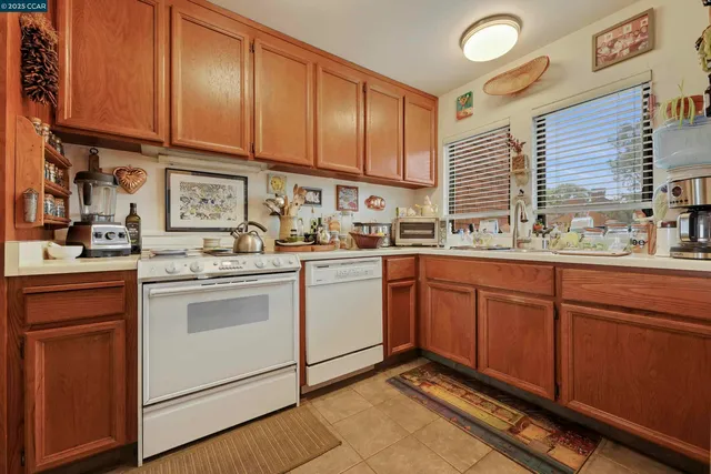 a kitchen with a sink and a stove top oven