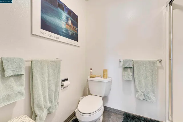 a bathroom with a sink mirror vanity and toilet