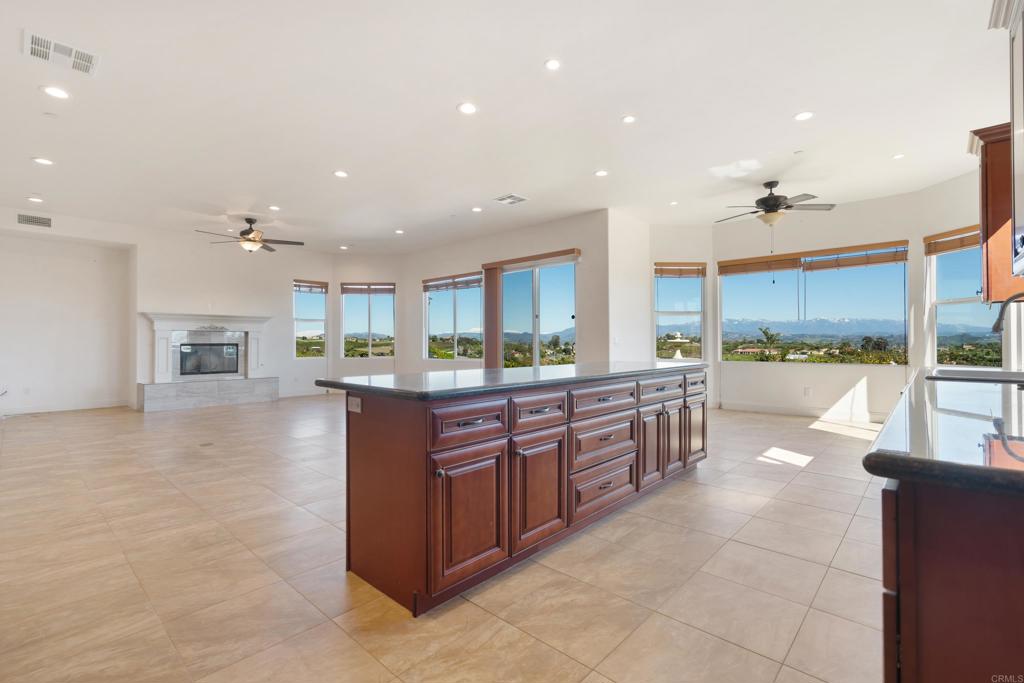 4261 Entrada Al Sol Bonsall, CA 92003 - Photo 14 of 49 a large kitchen with kitchen island a large counter top and stainless steel appliances
