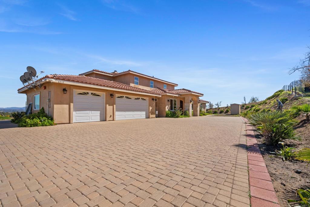 4261 Entrada Al Sol Bonsall, CA 92003 - Photo 2 of 49 a front view of a house with a yard