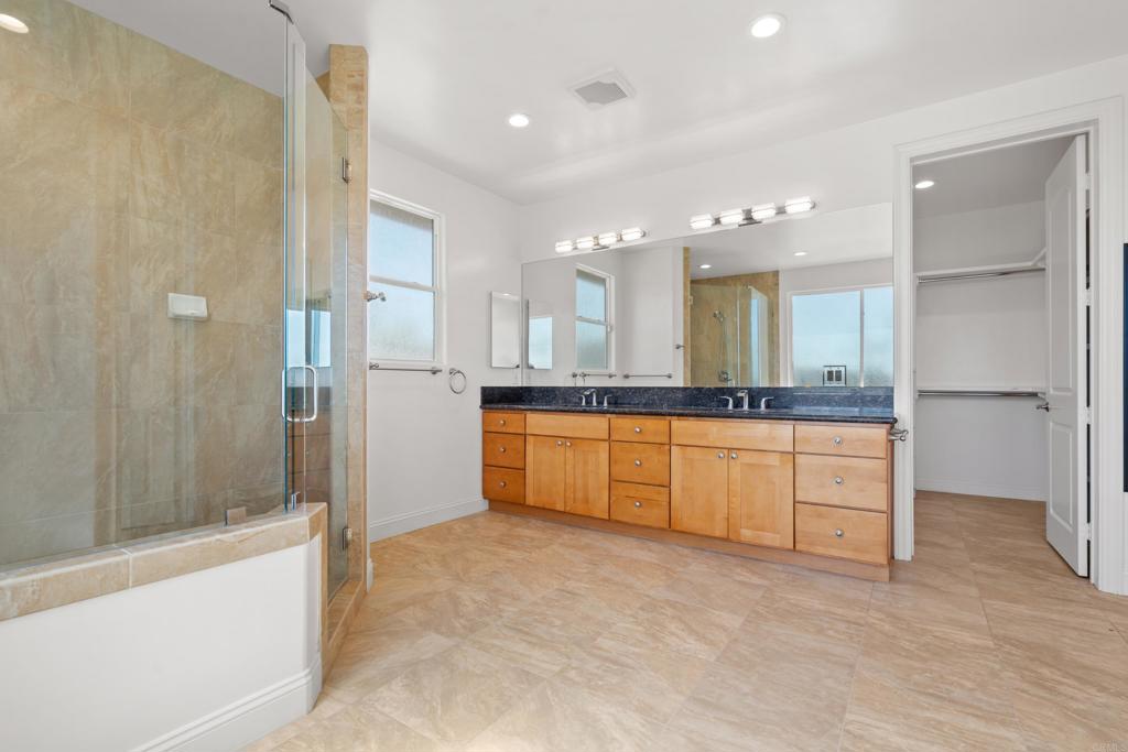 4261 Entrada Al Sol Bonsall, CA 92003 - Photo 24 of 49 a large bathroom with a large tub shower vanity and a sink