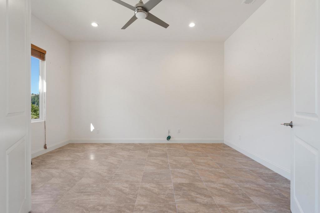 4261 Entrada Al Sol Bonsall, CA 92003 - Photo 26 of 49 an empty room with a ceiling fan and window