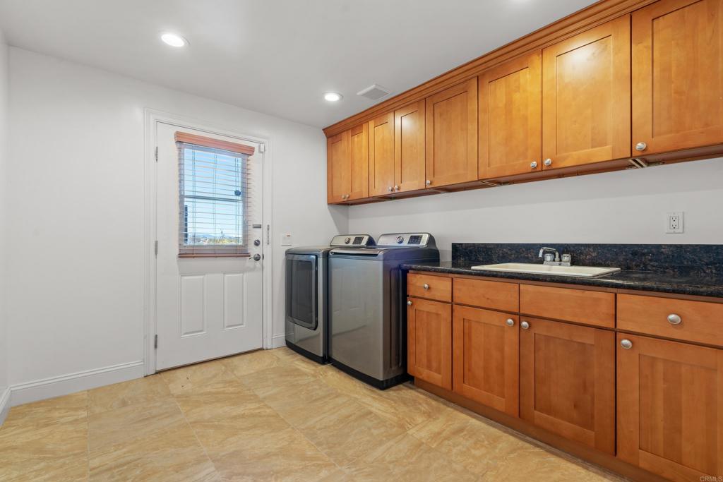 4261 Entrada Al Sol Bonsall, CA 92003 - Photo 30 of 49 a kitchen with stainless steel appliances granite countertop a refrigerator sink and cabinets