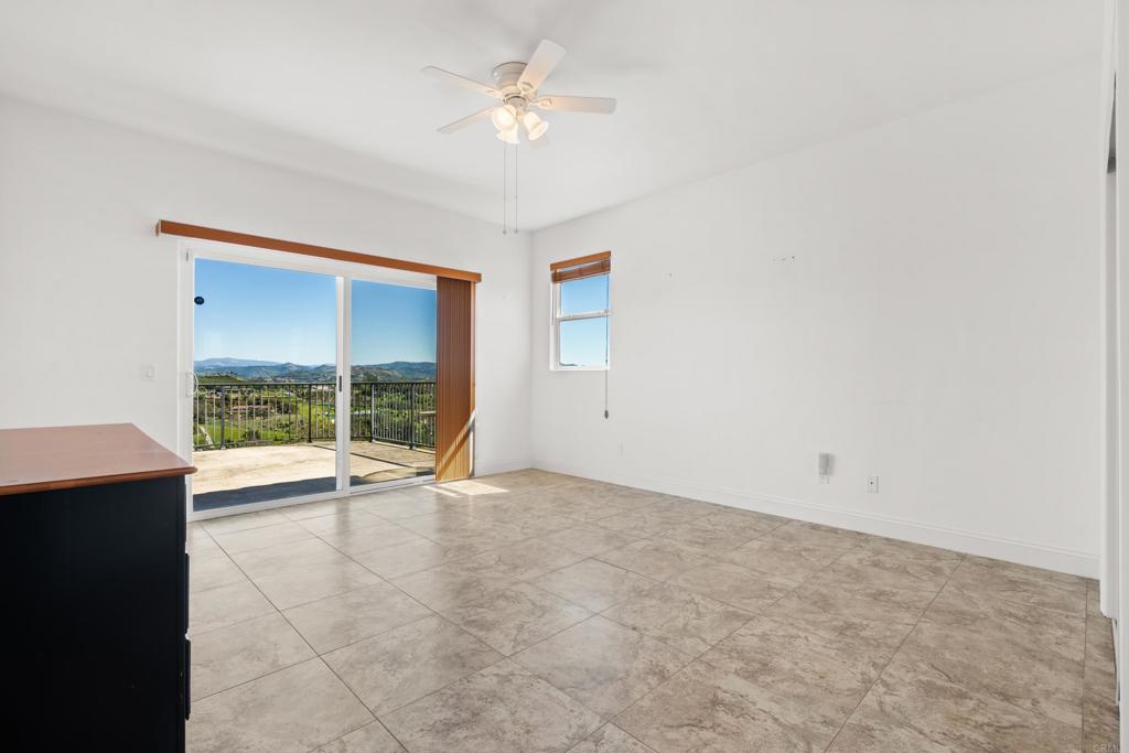 4261 Entrada Al Sol Bonsall, CA 92003 - Photo 32 of 49 an empty room with large windows
