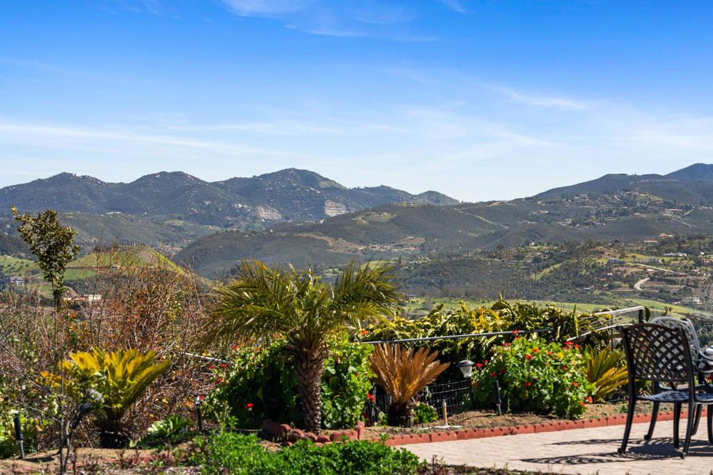 4261 Entrada Al Sol Bonsall, CA 92003 - Photo 40 of 49 a view of a mountain with a garden