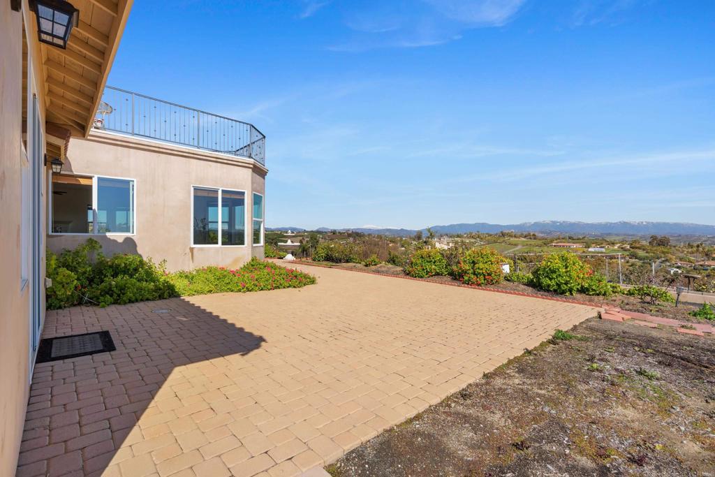 4261 Entrada Al Sol Bonsall, CA 92003 - Photo 41 of 49 a view of an ocean with a building in the background