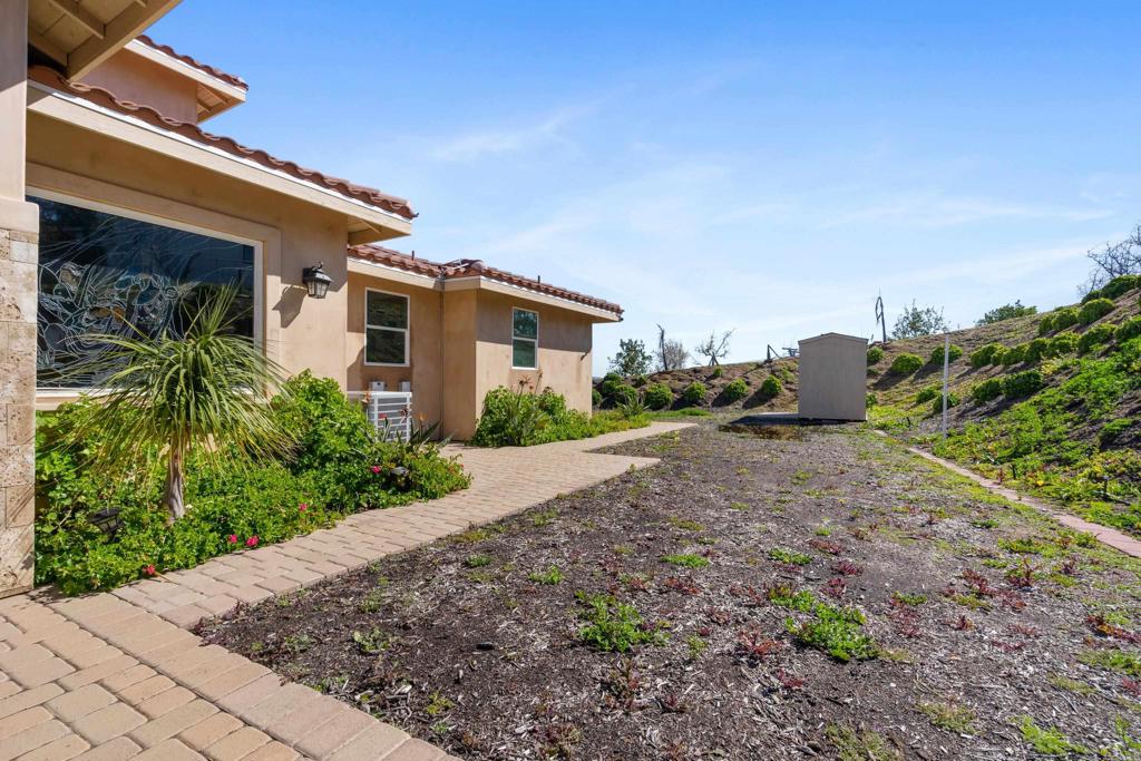 4261 Entrada Al Sol Bonsall, CA 92003 - Photo 44 of 49 a front view of a house with plants and trees