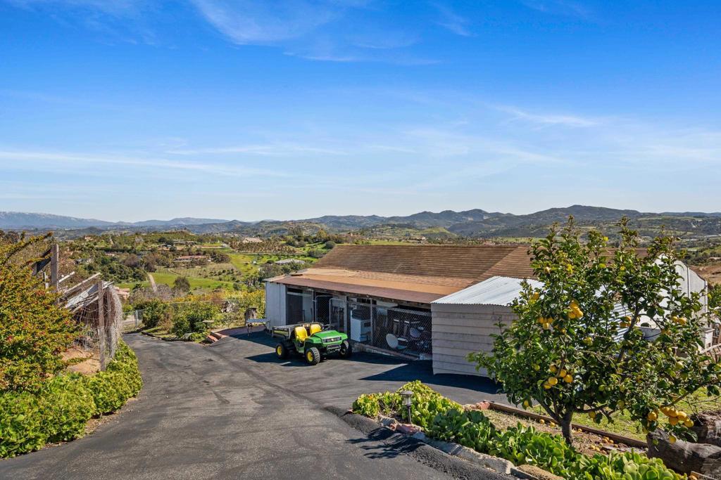 4261 Entrada Al Sol Bonsall, CA 92003 - Photo 45 of 49 an aerial view of a house with a garden and balcony