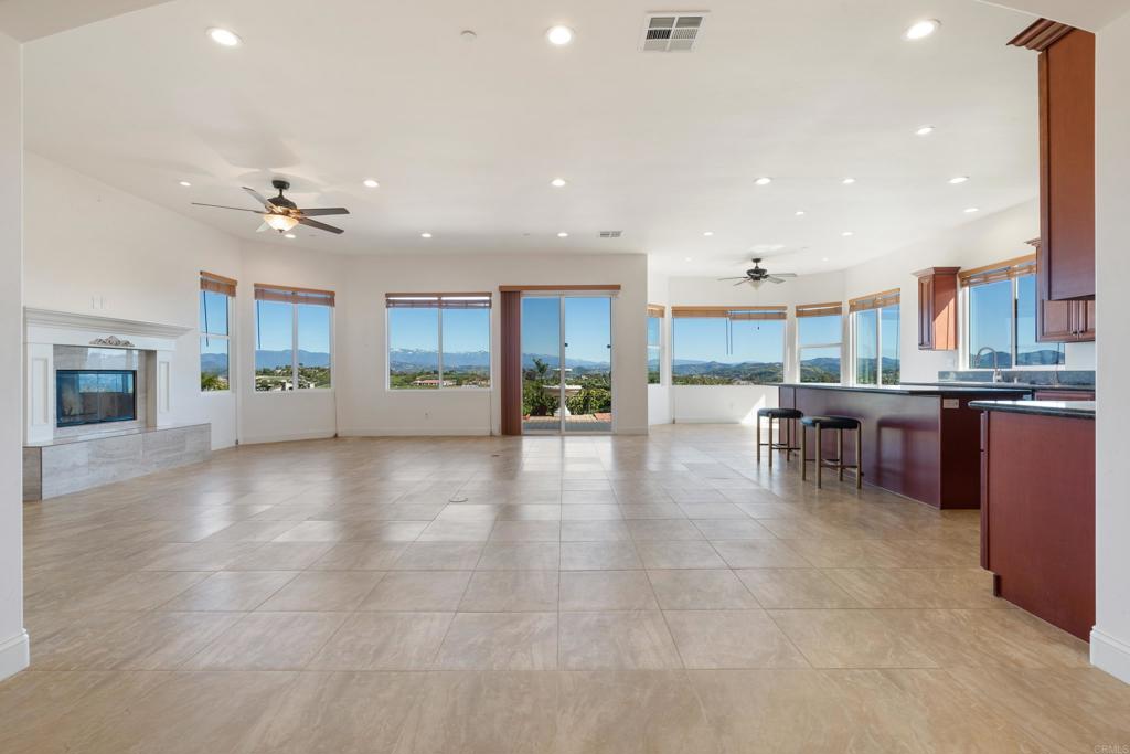 4261 Entrada Al Sol Bonsall, CA 92003 - Photo 6 of 49 a view of a kitchen with kitchen island stainless steel appliances refrigerator sink dining table and chairs