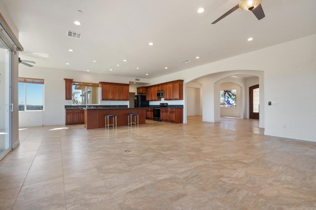 4261 Entrada Al Sol Bonsall, CA 92003 - Photo 9 of 49 a view of kitchen with furniture and a flat screen tv