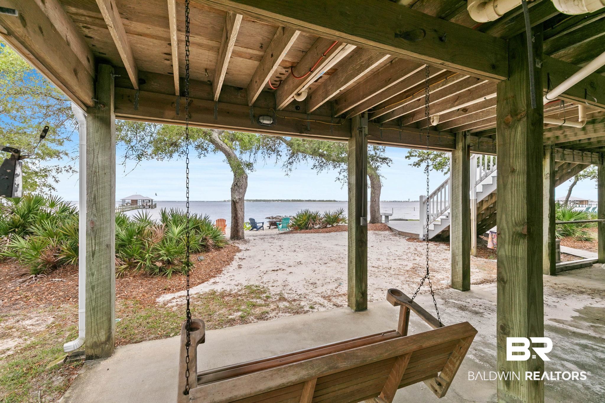 6802 Shore Drive Elberta, AL 36530 - Photo 5 of 34 Waterfront property featuring a sandy ground-level area with mature trees and native landscaping