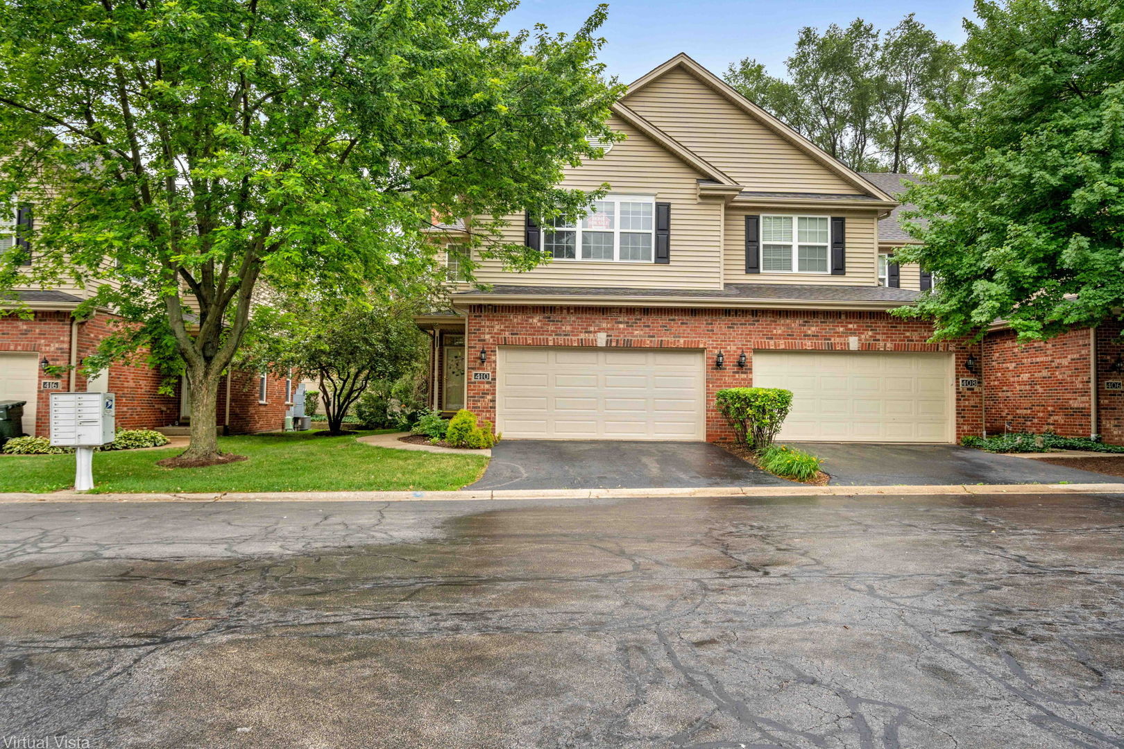 a front view of a house with a yard and a garage
