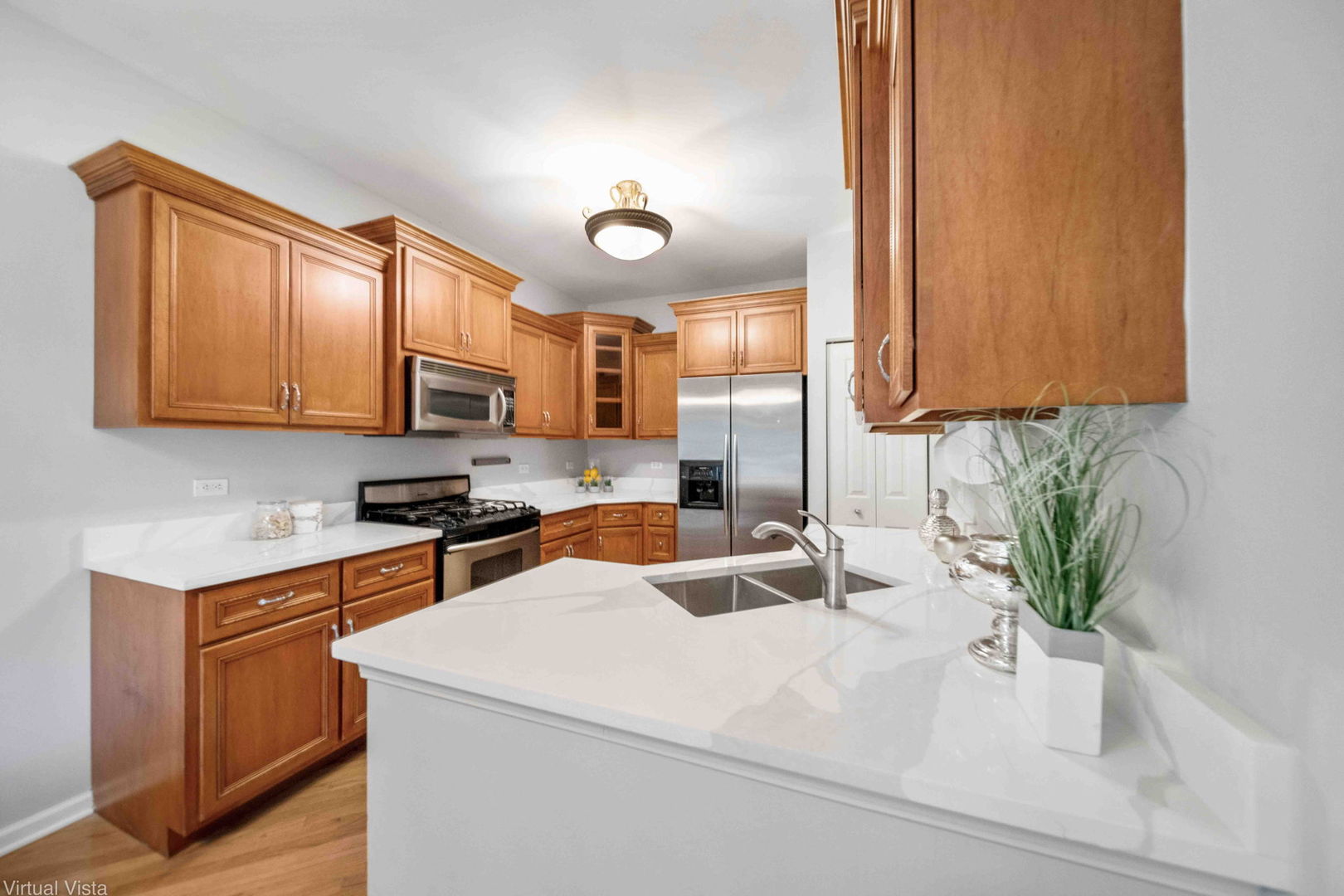 410 North River Road Naperville, IL 60540 - Photo 12 of 29 a kitchen with stainless steel appliances granite countertop a sink a stove and a microwave