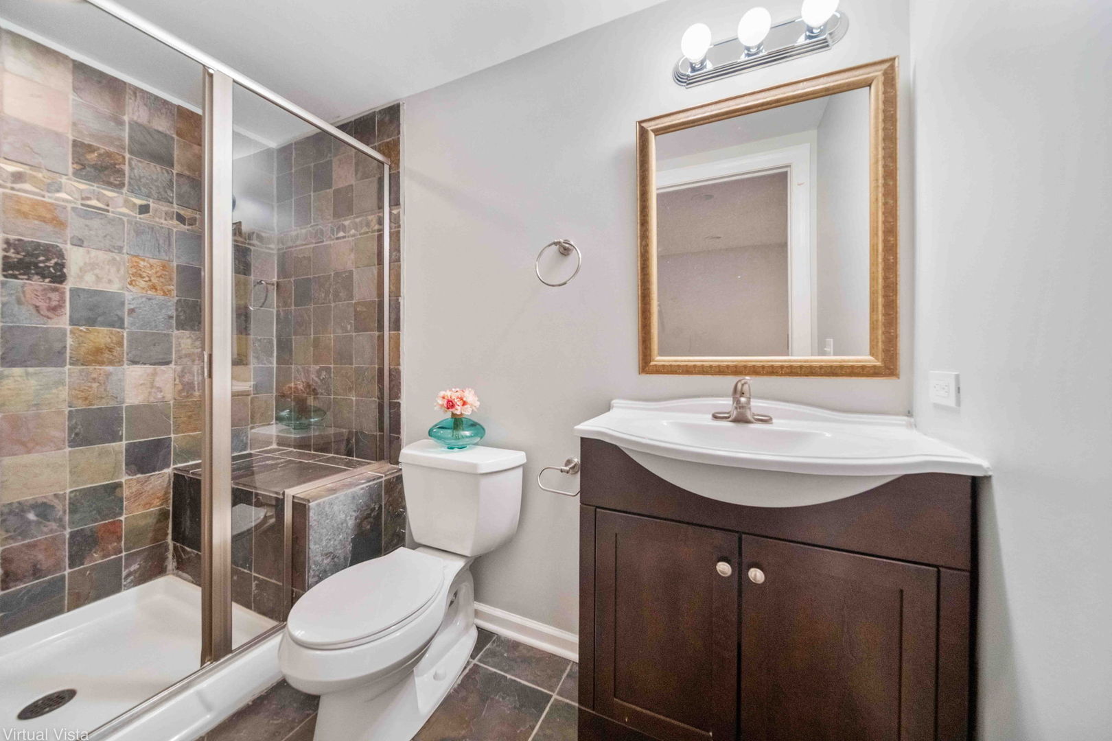 410 North River Road Naperville, IL 60540 - Photo 27 of 29 a bathroom with a sink toilet a mirror and shower