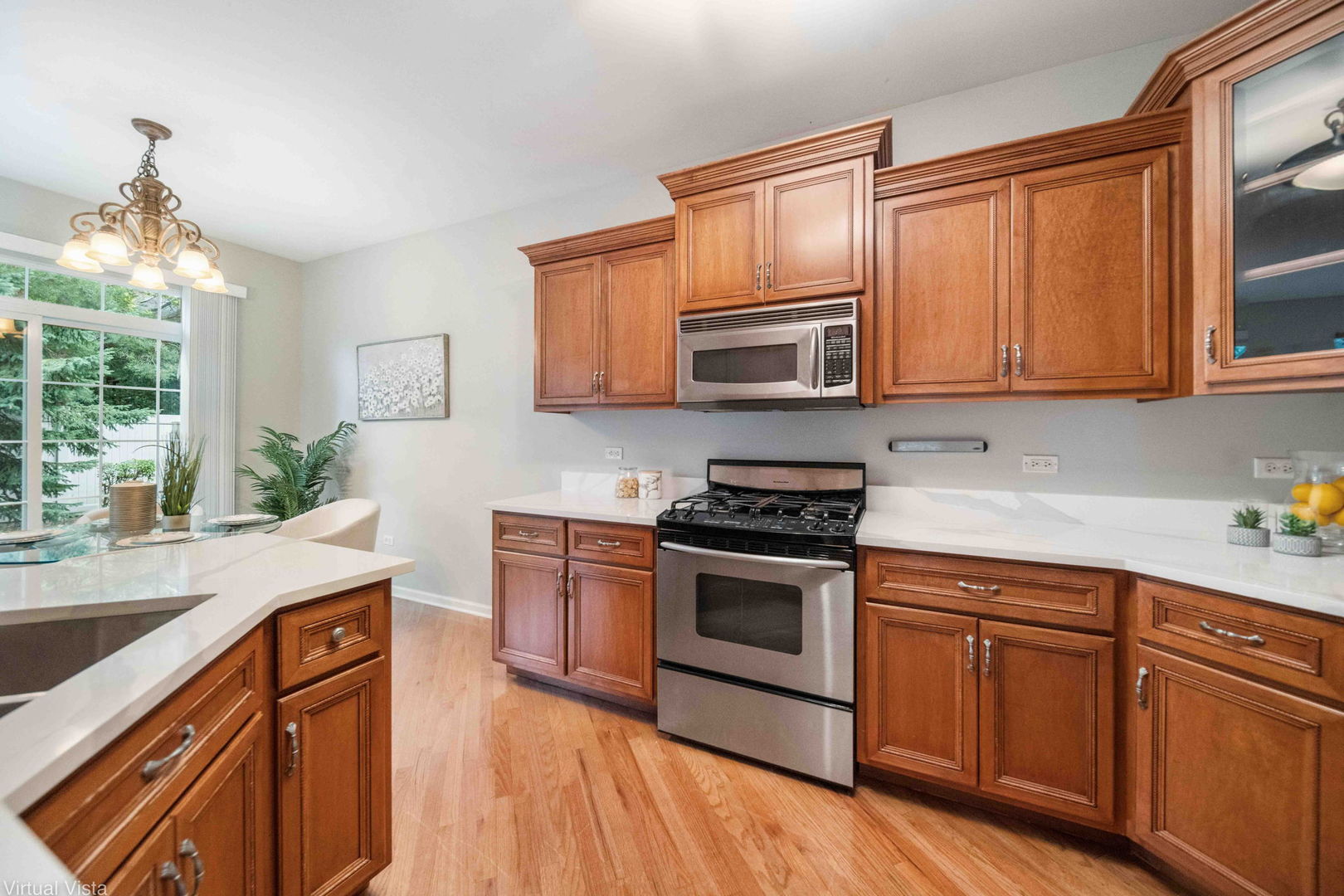 410 North River Road Naperville, IL 60540 - Photo 10 of 29 a kitchen with granite countertop wooden cabinets stainless steel appliances and a window