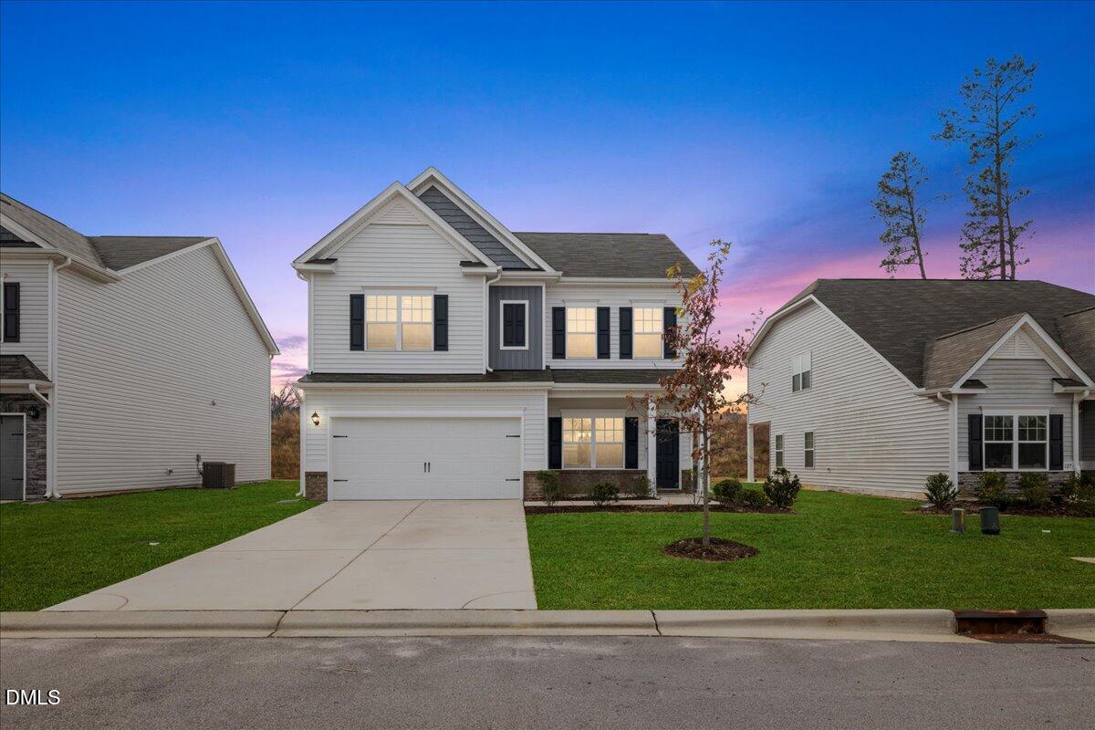 a front view of a house with a yard and garage
