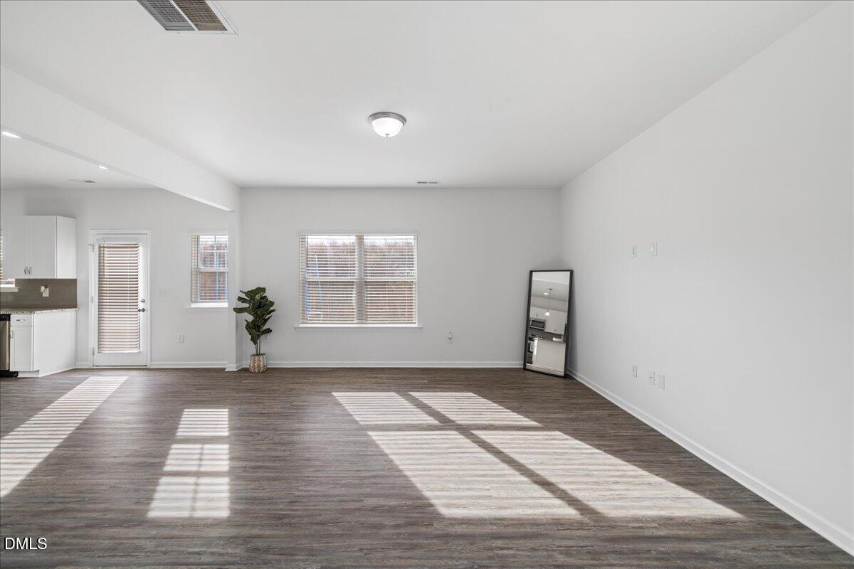 125 Flying Point Lane Clayton, NC 27520 - Photo 10 of 50 a view of an empty room with wooden floor and a window