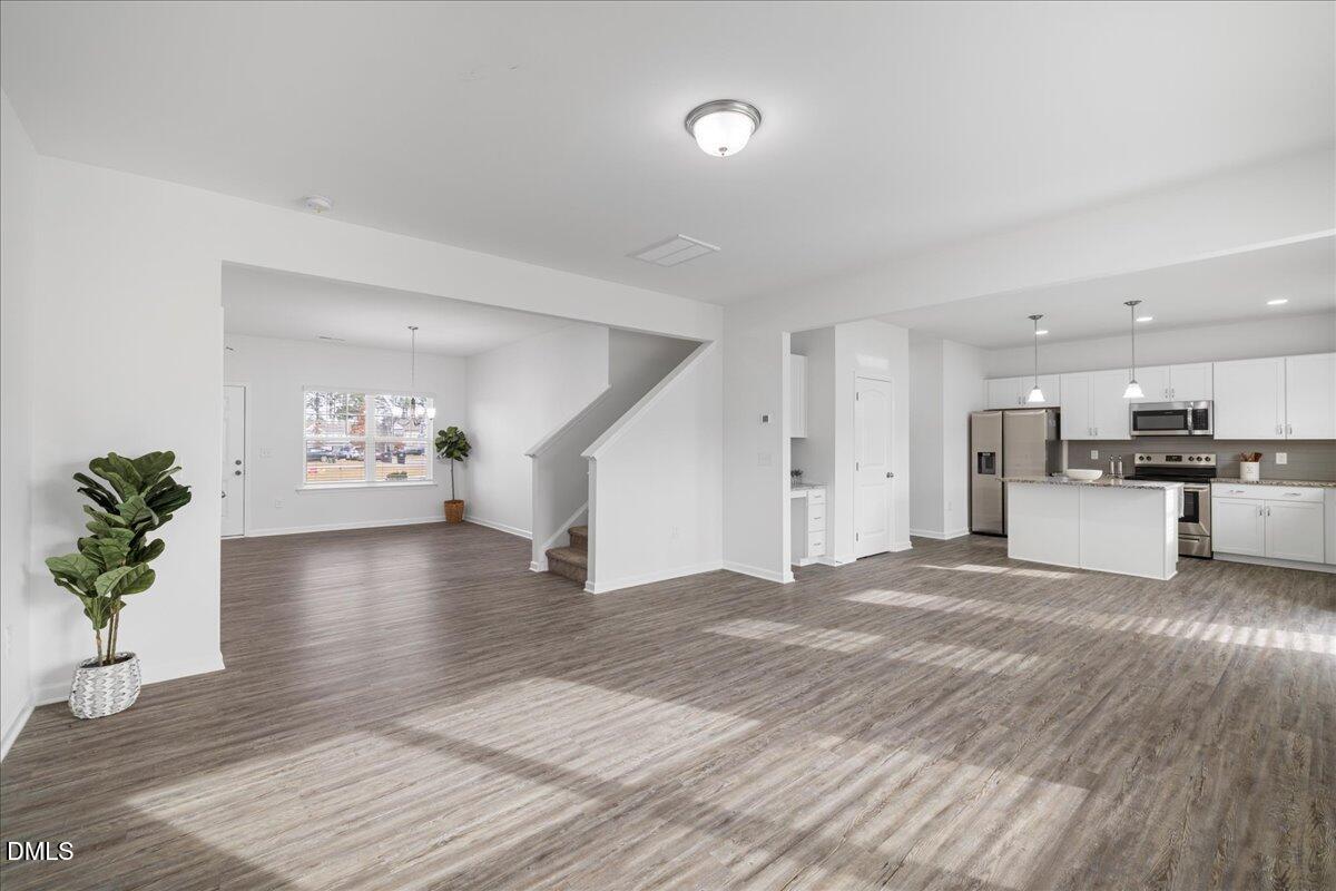 125 Flying Point Lane Clayton, NC 27520 - Photo 12 of 50 a view of kitchen with furniture and wooden floor