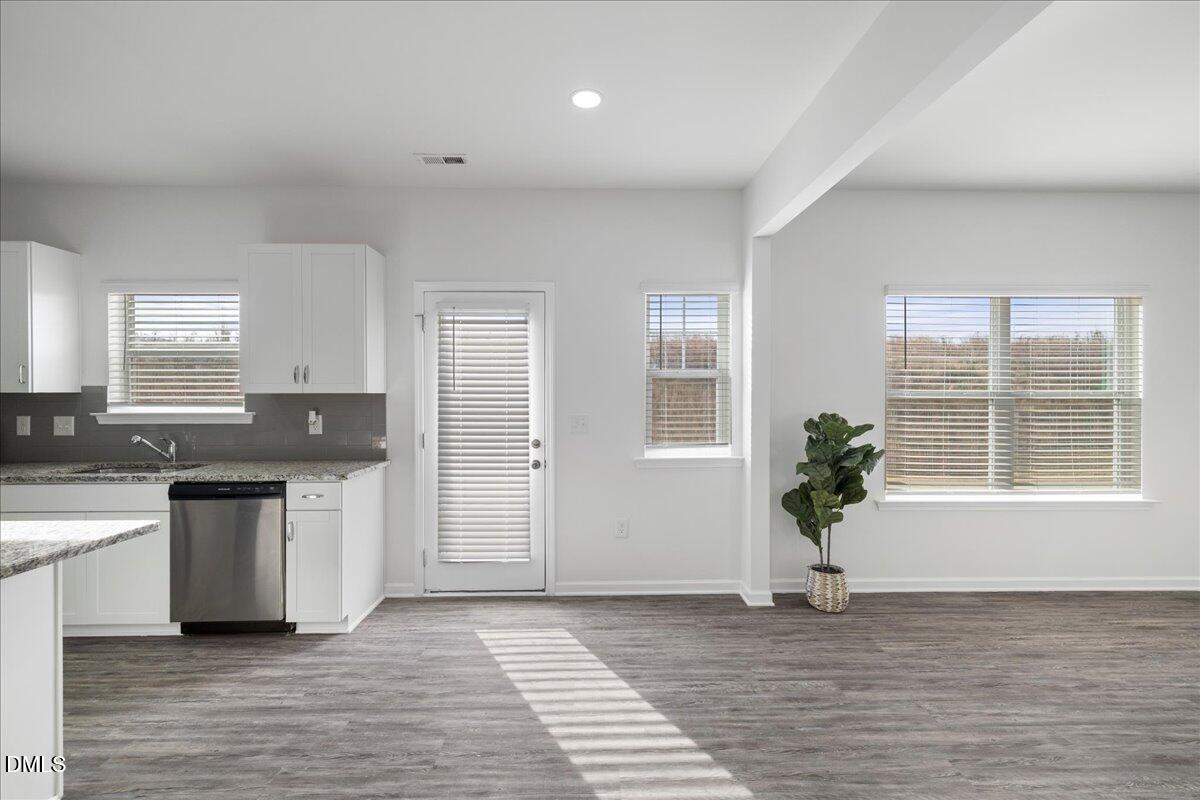 125 Flying Point Lane Clayton, NC 27520 - Photo 15 of 50 a kitchen with a sink and a white cabinets