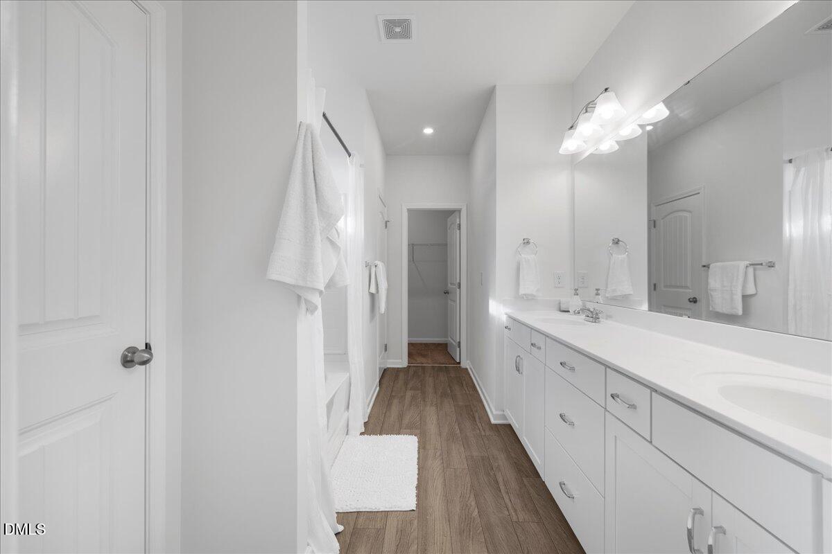 125 Flying Point Lane Clayton, NC 27520 - Photo 26 of 50 a spacious bathroom with a double vanity sink and a mirror