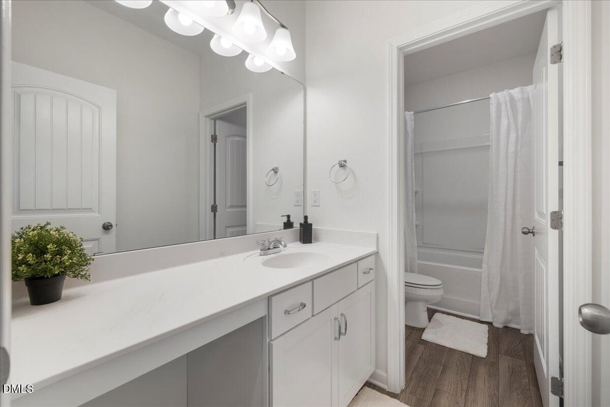 125 Flying Point Lane Clayton, NC 27520 - Photo 35 of 50 a bathroom with a sink a vanity and a mirror