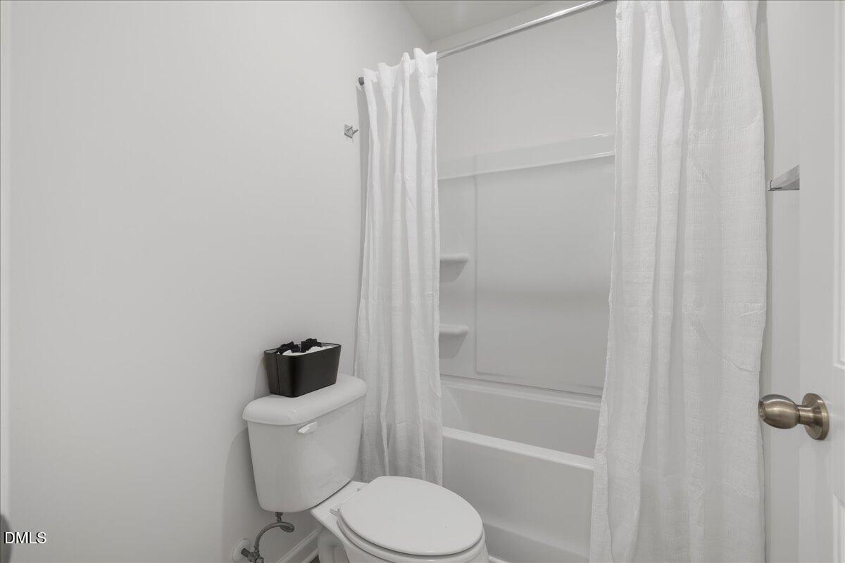 125 Flying Point Lane Clayton, NC 27520 - Photo 36 of 50 a white toilet sitting next to a shower