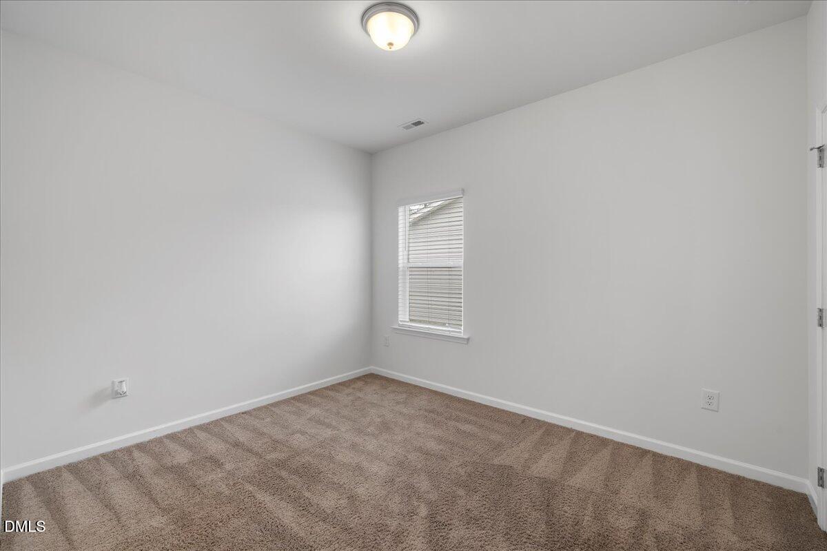 125 Flying Point Lane Clayton, NC 27520 - Photo 39 of 50 an empty room with a window