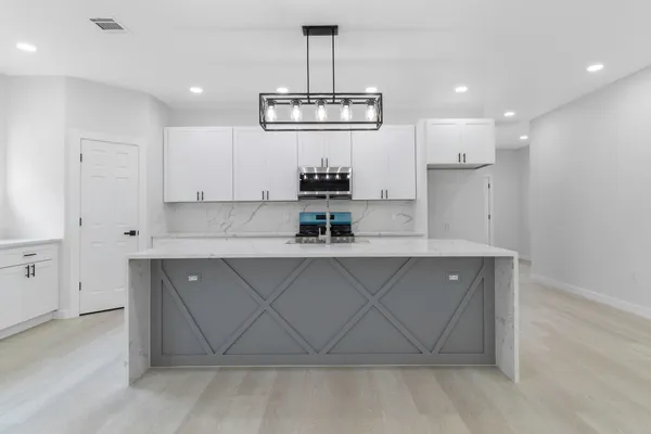 a kitchen with a sink stainless steel appliances and cabinets
