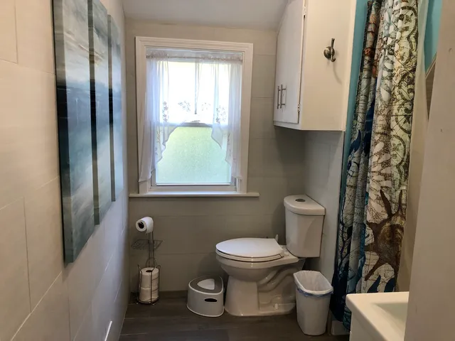 a white toilet sitting next to a bathroom sink