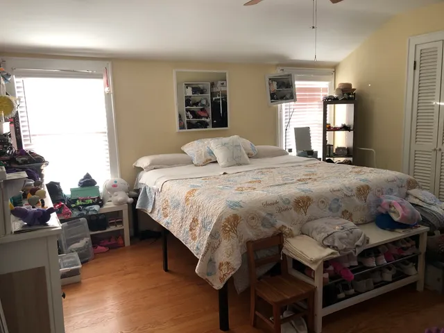 a bedroom with a bed and a window