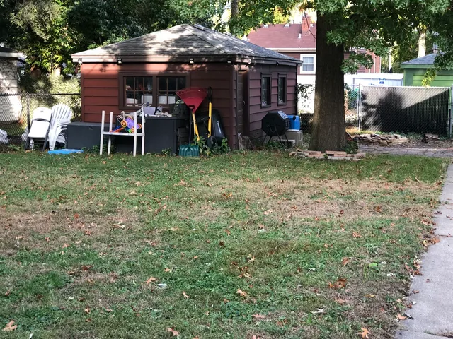 a view of a chairs and tables in the back yard of the house
